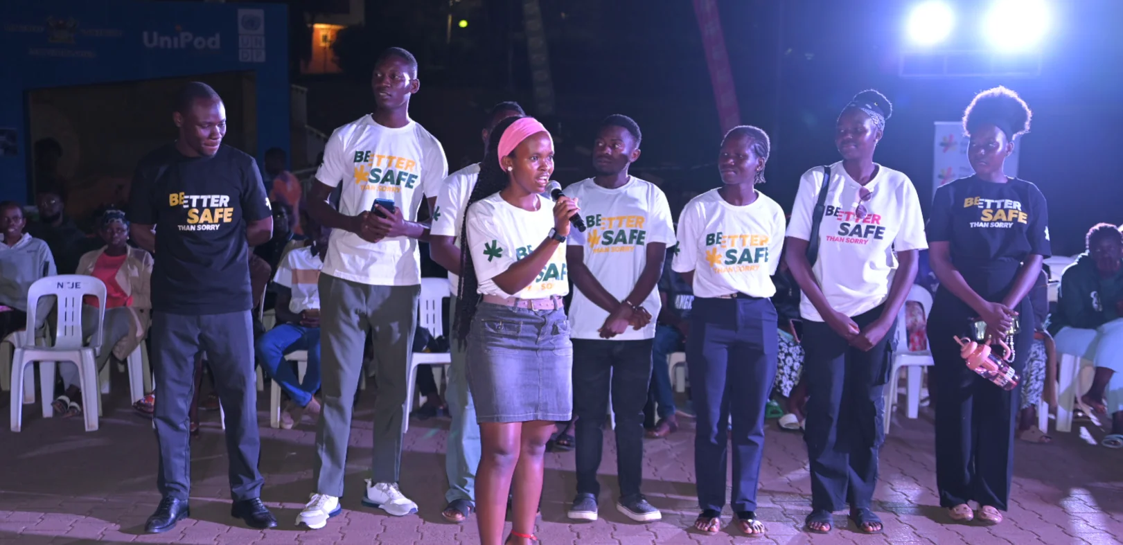 Ugandan university student speaking to fellow students on campus