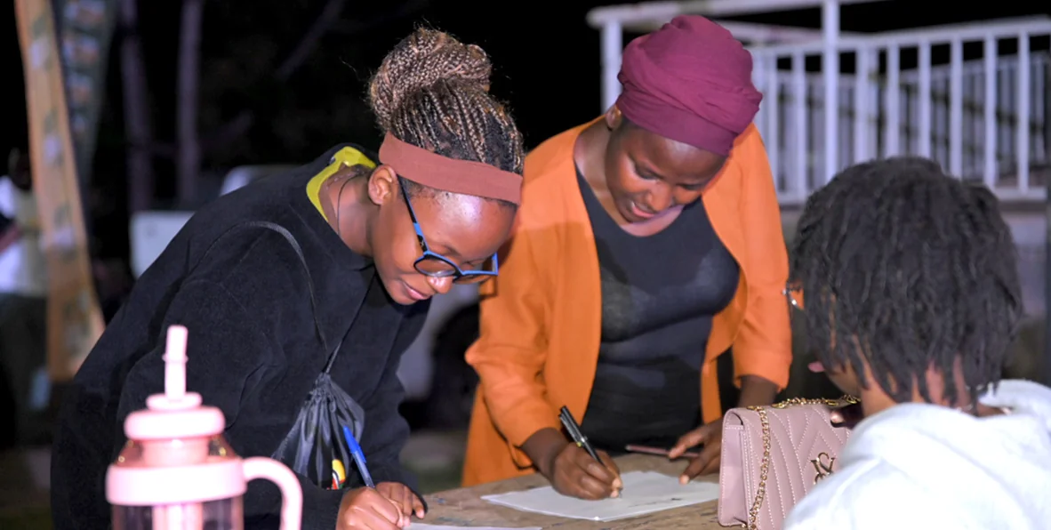 Ugandan students and mentors planning together around a table