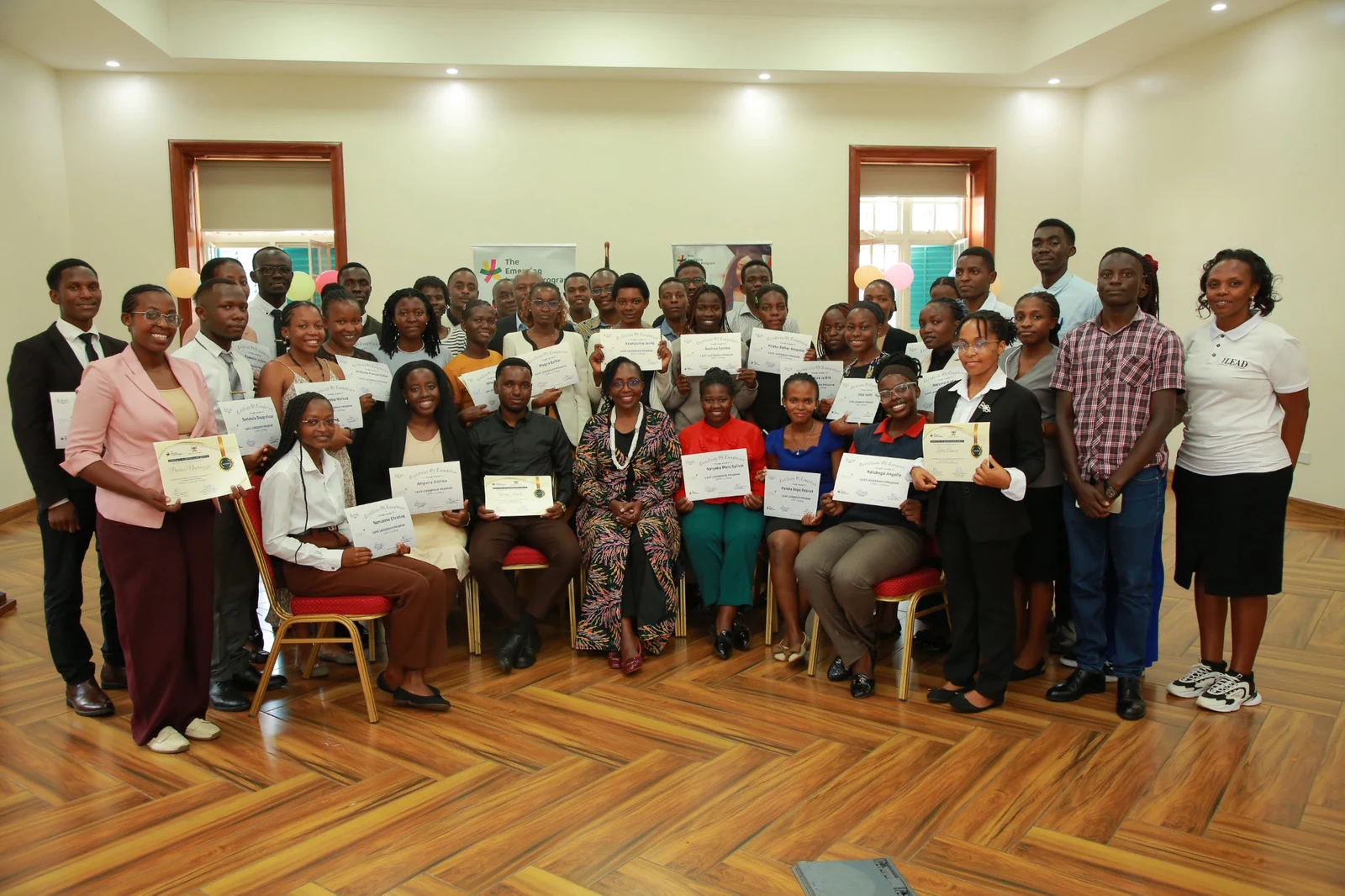 Students holding certificates at an ELP SAFE-iLEAD graduation gathering.